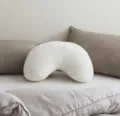 White plush crescent pillow, soft ergonomic side sleeping cushion for bedroom, sofa, and bed. - V-shaped