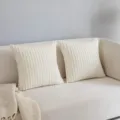 Corduroy throw pillow detail shot showcasing soft textured fabric on a cozy living room sofa. - Off White