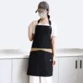 Tablier en toile noir et marron avec anneaux métalliques et poches pour cuisine ou salon. - Toile Épaisse Tour de Cou / Noir