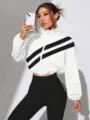 Detailed view of the women's white cropped stand-collar jacket featuring black diagonal stripes. - S / White