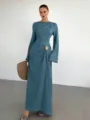 Close-up detail of the elegant blue dress with textured pleats and chic gold buckle accent. - S / Lake Blue