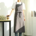 Grey cotton linen apron with pockets and cross-back straps, ideal for kitchen and café work. - Black and Gray