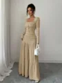 Detailed view of the khaki long-sleeve maxi dress with textured fabric and buttons. - S / Khaki