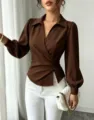 Detailed view of the elegant brown wrap V-neck blouse with long puff sleeves and waist tie. - S / Coffee