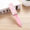 Portable pink lint roller with cute white polka dots for easy clothes dust and hair removal. - Pink