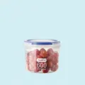 Doorzichtige plastic voorraadpot met blauwe deksel en sluiting, compacte keukenmaat. - 600ml
