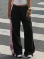 Detail shot of Y2K high waist black casual pants featuring pink side stripes, trendy streetwear style. - S / Black Pink Stripes