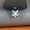 Close-up detail of a creative black and white tiger head phone charm pendant, metal drip oil. - Tiger / Suitable for Type-C Interface