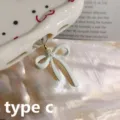 Close-up detail of Type-C phone dust plug featuring an elegant solid white bow and pearl pendant. - Style 4 / iOS Phone (Lightning)