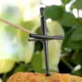 Detailed closeup of a black stainless steel cross pendant styled like miniature baseball bats. - Pendant Only (Without Chain) / Black