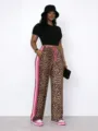 Detail view of women's leopard print wide-leg pants with pink side stripes and elastic waist. - S / Bottoms / Pink Leopard Print