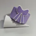 Purple silicone cup sleeve detail shot featuring a cute bow decoration for standard drinkware. - Purple