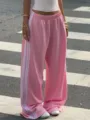 Pink wide-leg track pants with white side stripes, casual streetwear style, comfy fit. - Pink