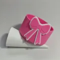 Silicone cup sleeve detail view, pink bow design, protective cover for water tumbler accessories. - Pink