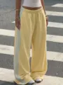 Trendy yellow loose sweatpants with blue side stripes, comfortable streetwear wide leg pants. - S / Bottoms / Yellow