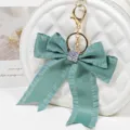 Pleated ribbon bow bag charm with sparkly rhinestones and gold keychain for stylish women accessories. - Style 1