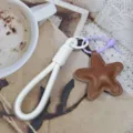 Detailed view of white woven phone lanyard keychain with brown star pendant for daily use. - Star Style 7