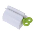 White plastic toothpaste squeezer dispenser, green rotary key variant for facial cleanser. - Green