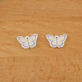 Close-up detail of small purple yellow enamel butterfly charms, perfect for DIY jewelry crafting. - Purple Butterfly