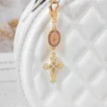 Gold alloy rhinestone cross keychain bag charm with pink medallion, stylish religious accessory. - Pink
