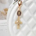 Gold alloy rhinestone cross charm keychain with pearl details and religious pendant for bags. - Black