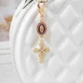 Gold alloy cross charm pendant with pearls and rhinestones, stylish bag keyring accessory. - Deep purple