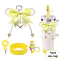Detailed view of the 4pcs yellow pearl bow keychain and cute bear straw cap for tumbler cups. - Picture 12