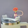 Close-up detail of the cute pink flower silicone straw cover and dust cap accessory. - Without Straw / Pattern 1