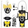 Detailed view of Stanley tumbler accessories set including pearl strap, bow keychain and straw topper. - Picture 1
