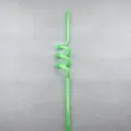 Close-up detail shot of a creative green spiral plastic straw, perfect for party drinks. - Green