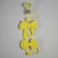 Yellow silicone straw cover detail showing diamond and bow straw topper designs clearly. - Yellow