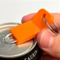 Orange plastic can opener keychain, portable pull tab beer opener tool for easy beverage opening. - Orange