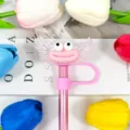 Cute pink acrylic angel wings straw cover with funny expression and sausage lips design. - Yellow Warning Print