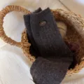 Dark brown wool mid-tube socks with button detail in woven basket product detail shot - One Size / Dark Coffee
