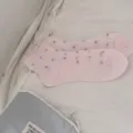 Detailed view of sweet pink ruffle short socks with tiny polka dots, lightweight and breathable. - Light Pink