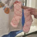 Cute pink ruffled mid-calf socks for women featuring a sweet bow lattice pattern. - One Size / Peach Pink