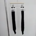 Black stirrup socks for women featuring elegant white lace trim at the top. Soft knit fabric. - One Size / Black