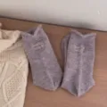 Cozy women's woolen knit socks with cute embroidered lettering and rolled cuff design for winter warmth. - One Size / Taro Purple