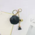 Schlüsselanhänger mit schwarzem Flausch-Pompon, goldener Kette, Glocke und Quaste. - Schwarz