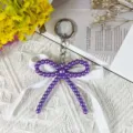 Purple pearl bow keychain detail with white lace ribbon and metal ring, sweet style. - Style 7