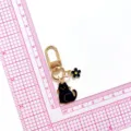 Porte-clés chat noir mignon en métal avec breloque fleur, pendentif de sac doré. - Noir