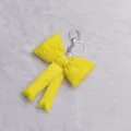 Cute yellow fabric bow keychain for women, stylish bag charm and adorable key ring accessory. - Yellow