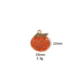 Detail shot of the enamel pumpkin pendant showcasing metal texture and vibrant autumn colors. - Enamel Painted Pumpkin