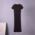Close-up detail of the knitted dress featuring chic contrast white ruffles on sleeves and hem. - S / Dresses / Brown