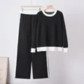 Detailed view of women's black and white contrast knit sweater and wide-leg pants set. - One Size / Top And Bottom / Black