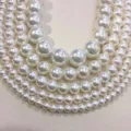 Vue détaillée de perles de nacre blanches à haute brillance pour bijoux DIY - 62 Pièces/Mèche (16mm) / Blanc