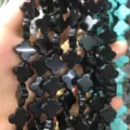 Close-up view of black stone clover-shaped loose beads for DIY jewelry necklace making. - 14x14x5mm (Approx 28 Units) / Black Agate