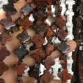 Close-up of four-leaf clover brown natural stone beads for DIY jewelry making - 14x14x5mm (Approx 28 Units) / Red and Black Obsidian