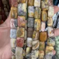 Close-up detail of variegated natural agate stone beads in rectangular shape for DIY crafts - Crazy Agate