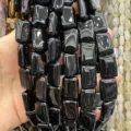 Macro view of polished rectangular double-arc black agate beads for handmade DIY jewelry - Black Agate
